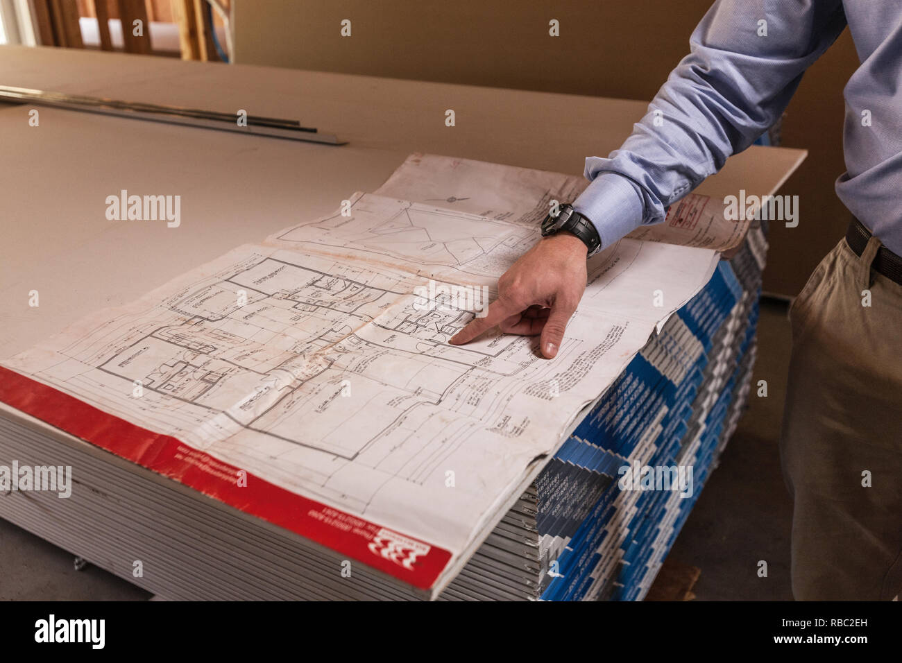 Man Pointing At Architectural Blueprint Stock Photo