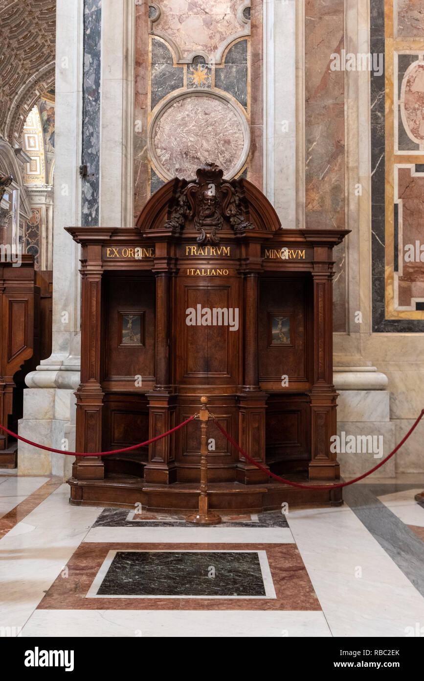 Rome, Italy - November 11 2018: Wooden confession booth in St. Peter Cathedral in Vatican Stock Photo
