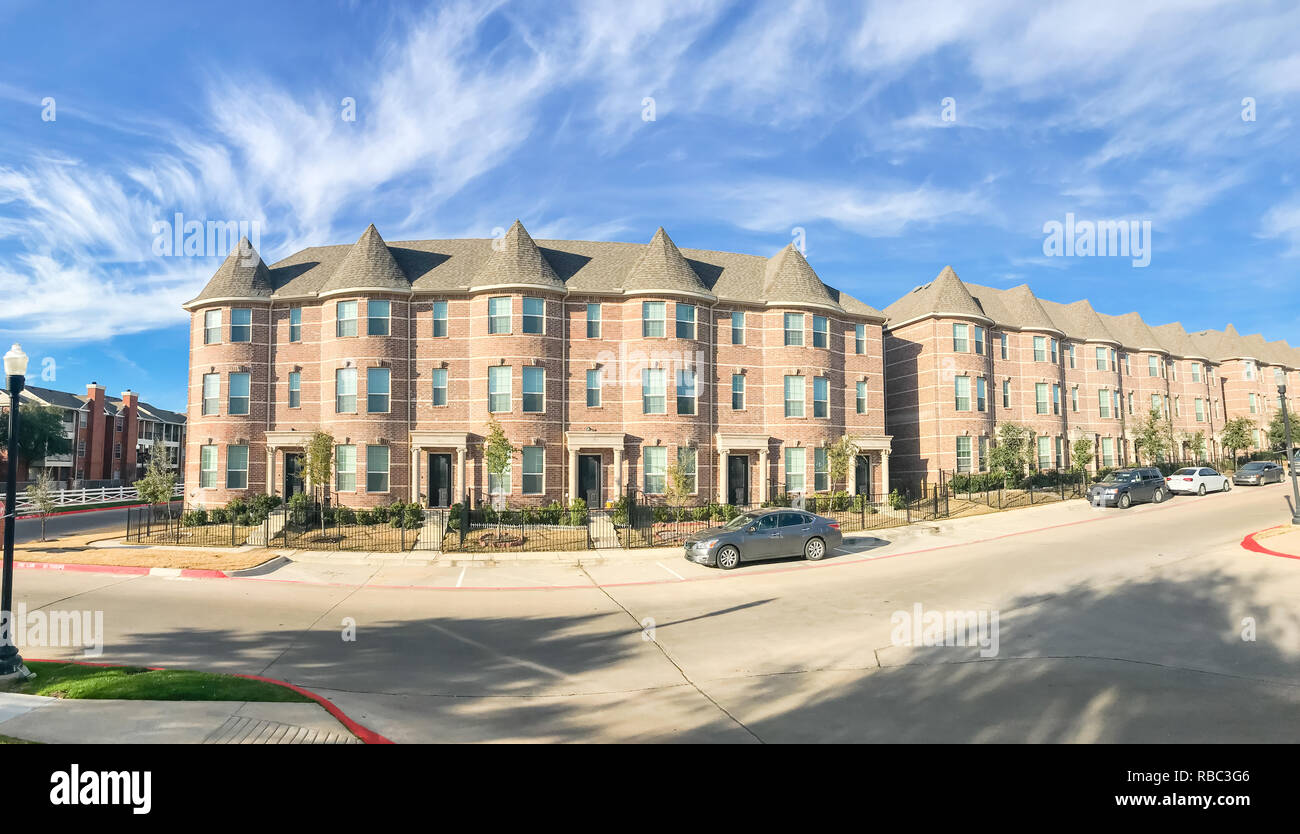 Panoramic view exterior of new townhouse apartment building near Stock