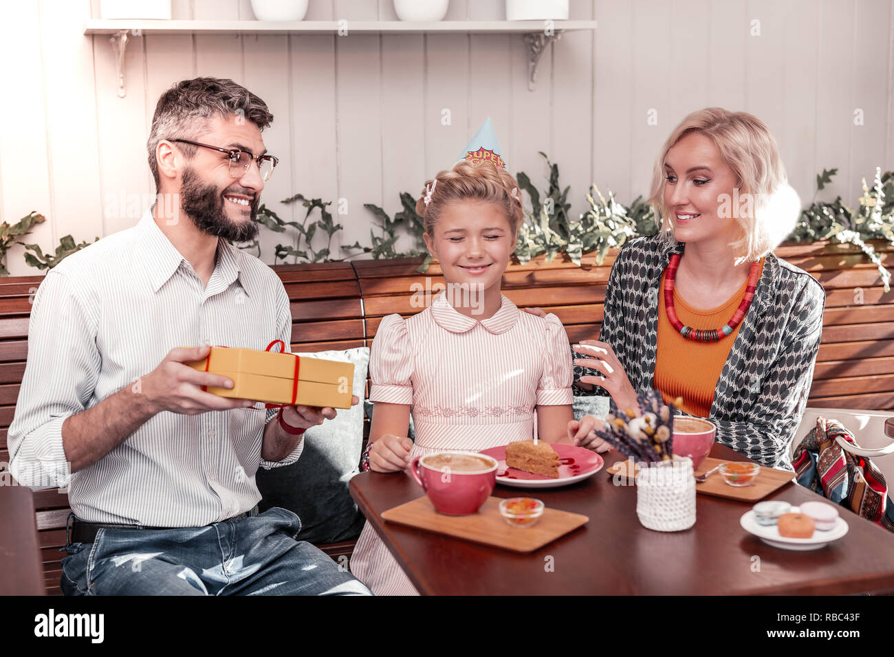 Happy cute girl sitting with her eyes closed Stock Photo - Alamy