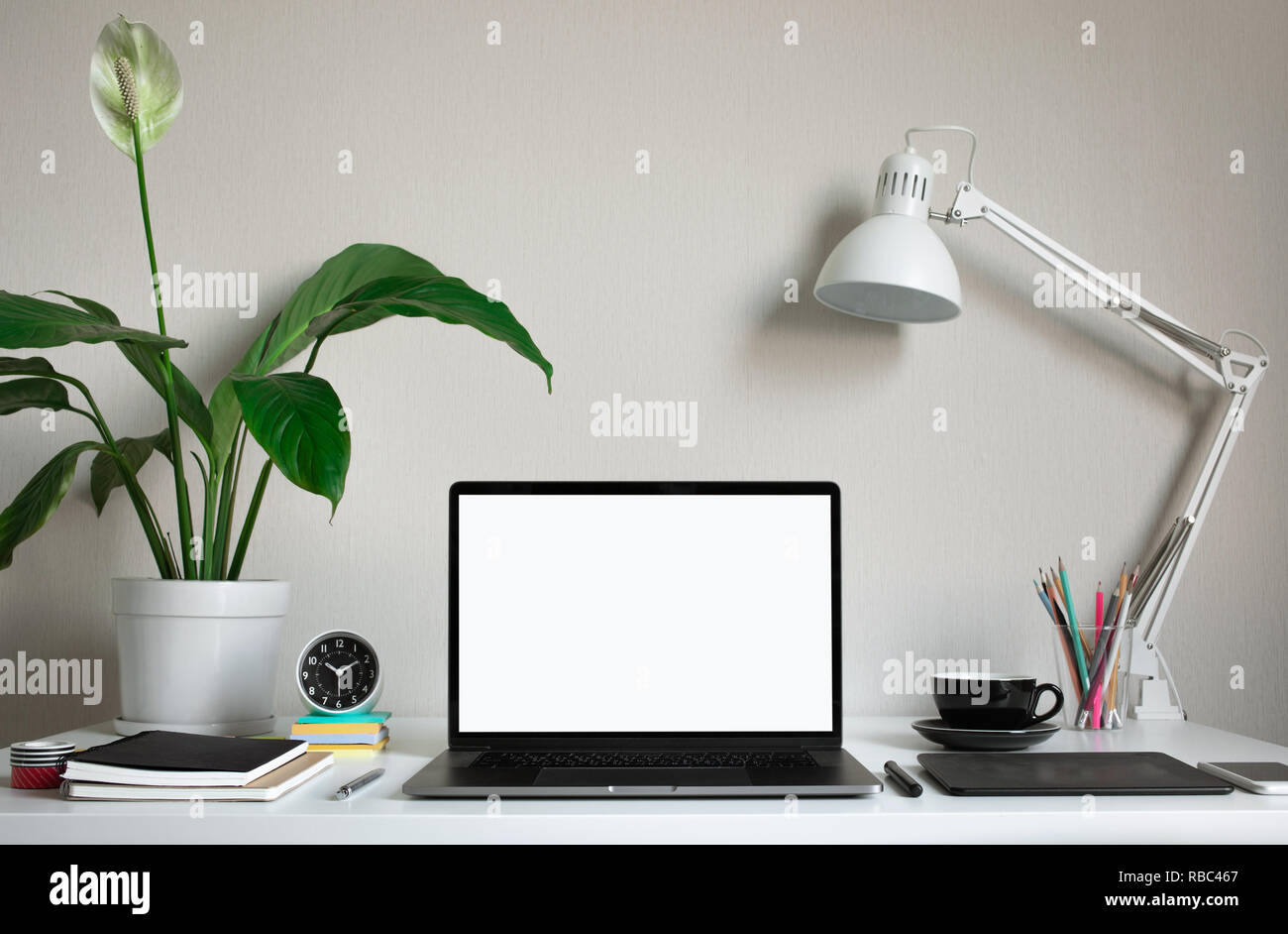 Modern work table with blank computer laptop and accessories in home office studio.Freelance designer or blogger concepts ideas.Background presentatio Stock Photo