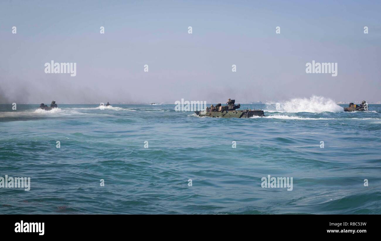 ARABIAN GULF - U.S. Marines with Kilo Company, Battalion Landing Team 3/1, 13th Marine Expeditionary Unit (MEU), navigate through the water with their amphibious assault vehicles, Nov. 29, 2018. The Essex Amphibious Ready Group and the 13th MEU are deployed to the U.S. 5th Fleet area of operations in support of naval operations to ensure maritime stability and security in the Central Region, connecting the Mediterranean and the Pacific through the western Indian Ocean and three strategic choke points. (U.S. Marine Corps photo by Cpl. Danny Gonzalez/Released) Stock Photo