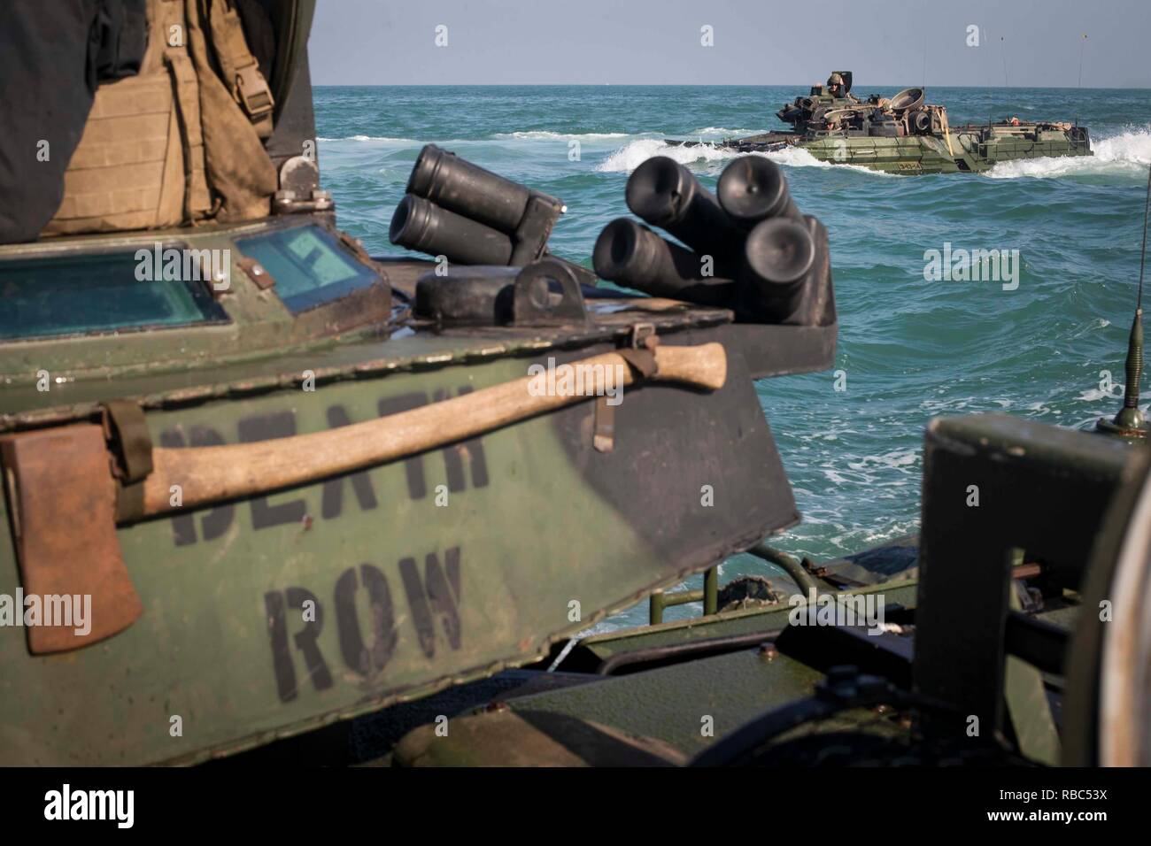 ARABIAN GULF - U.S. Marines with Kilo Company, Battalion Landing Team 3/1, 13th Marine Expeditionary Unit (MEU), steer through the water with their amphibious assault vehicles, Nov. 29, 2018. The Essex Amphibious Ready Group and the 13th MEU are deployed to the U.S. 5th Fleet area of operations in support of naval operations to ensure maritime stability and security in the Central Region, connecting the Mediterranean and the Pacific through the western Indian Ocean and three strategic choke points. (U.S. Marine Corps photo by Cpl. Danny Gonzalez/Released) Stock Photo