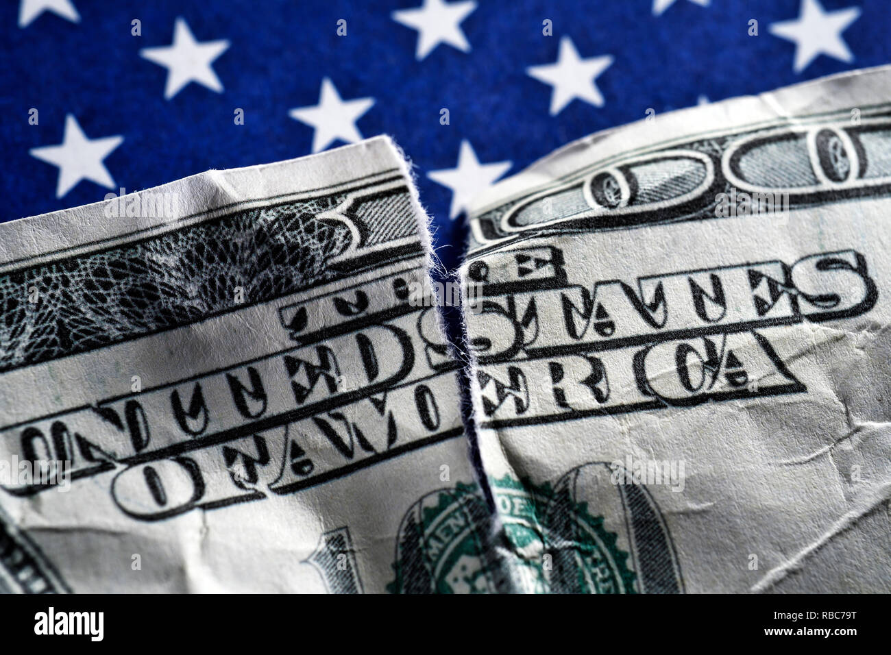 Torn dollar bill on US flag, US Government Shutdown Stock Photo