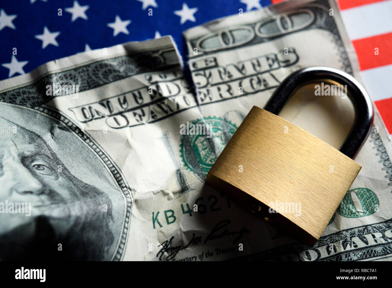 Dollar bill and padlock on US flag, US Government Shutdown Stock Photo