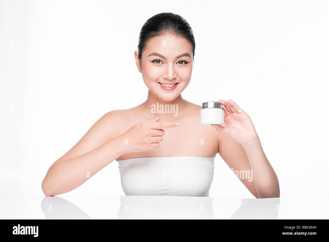 Beauty treatment. Asian woman holding serum moisturizing serum bottle Stock Photo