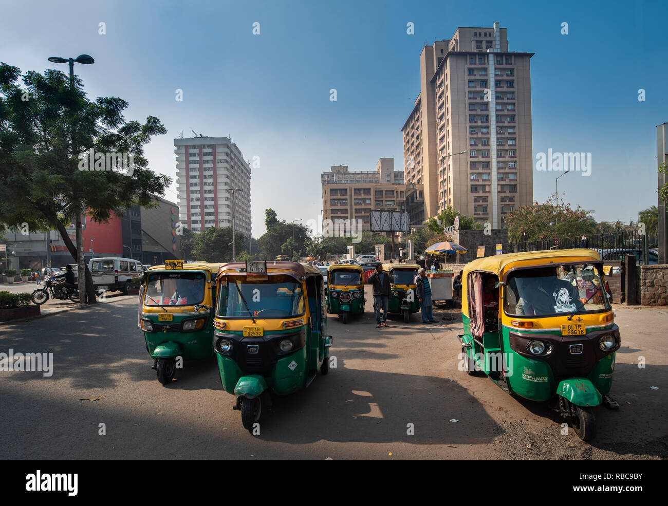 Auto rickshaws waiting for customers near Nehru Place Metro Station with Eros tower in the background, near Satyam Cinema. New Delhi, India Stock Photo