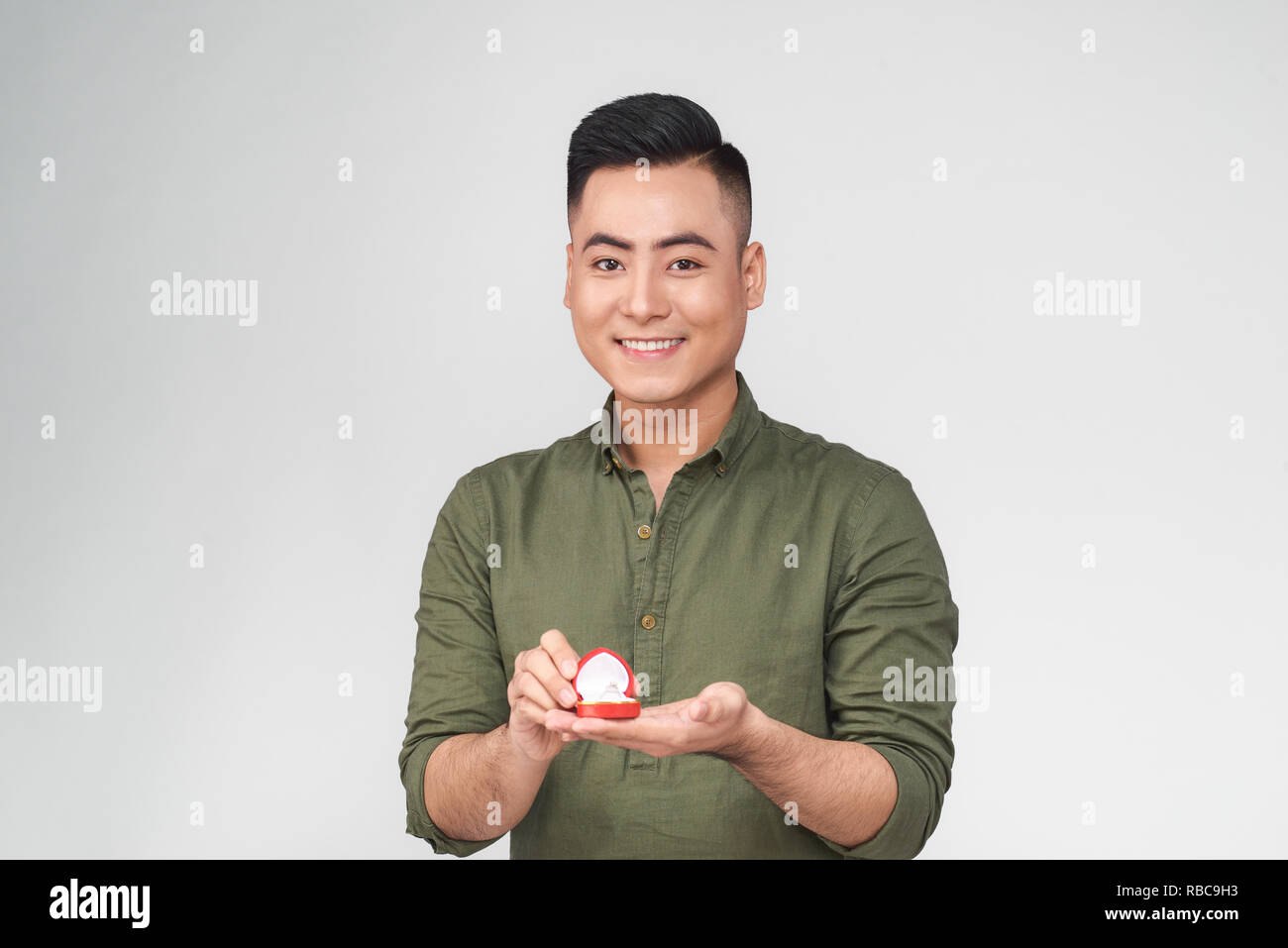 Asian man gives a ring with a diamond in a red box Stock Photo