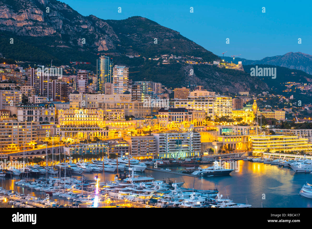 France, Provence-Alpes-Cote d'Azur, French Riviera, Alpes-Maritimes, Principality of Monaco. Monte Carlo illuminated at dusk. Stock Photo