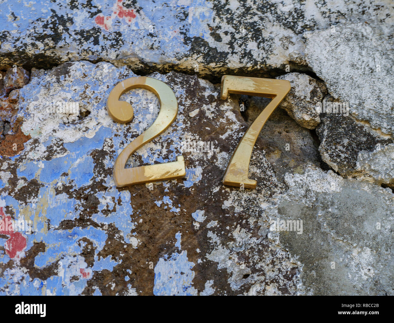 image of golden numbers on wall close up Stock Photo