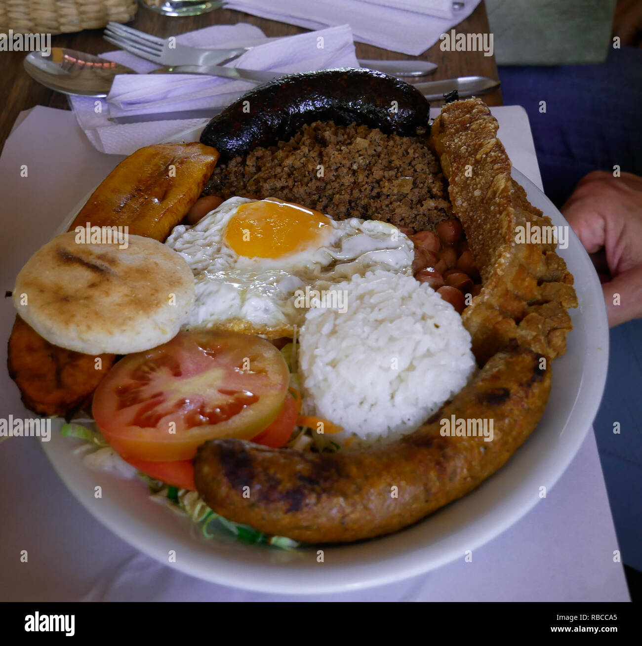 Dish of a typical food in Antioquia Colombia Bandeja Paisa with beans White rice sausage egg plantain mince meat Stock Photo