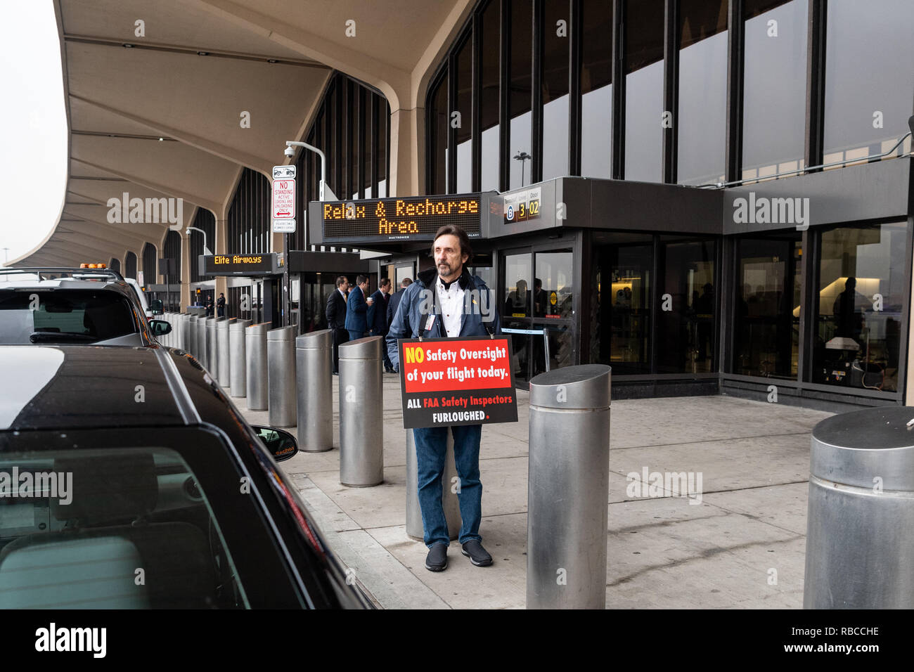 Protester seen outside a press conference in Terminal B at Newark Liberty International Airport with a placard telling people that FAA Safety Inspectors have been furloughed in Newark, New Jersey. Stock Photo