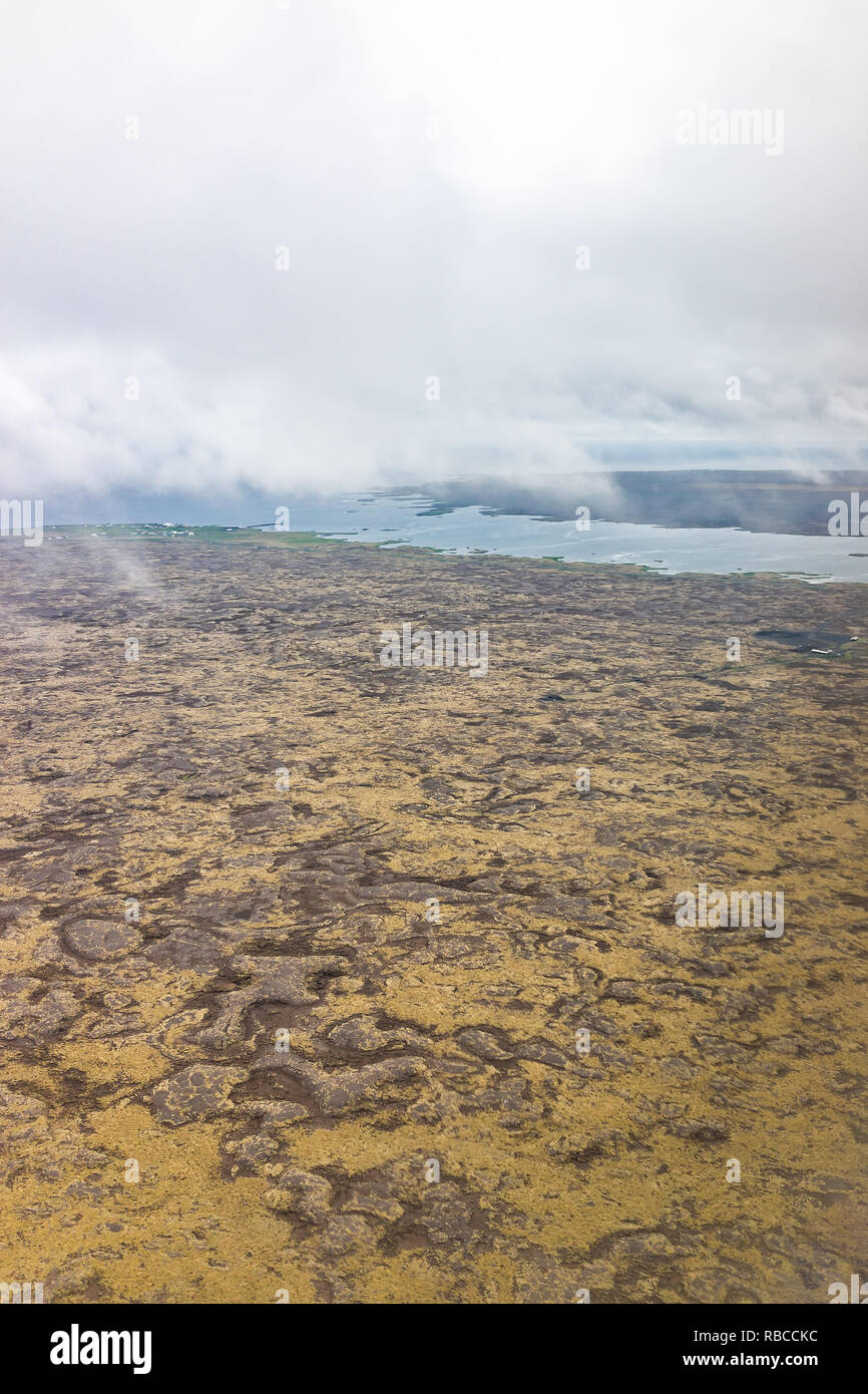 Keflavik, Iceland landscape view from airplane flying above the country, coastline with high angle aerial brown volcanic land Stock Photo