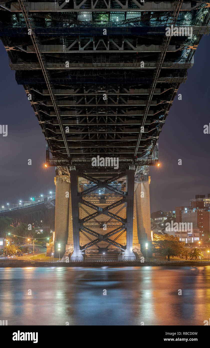 Bottom up view of  harbour bridge in Sydney Australia, Night Photography with reflection on the water Stock Photo