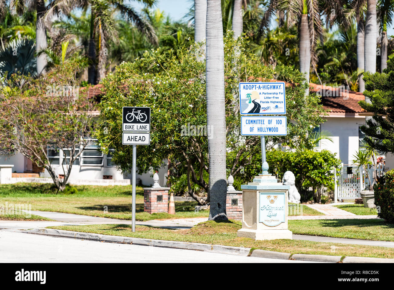 Hollywood, USA - May 6, 2018: City town street during sunny day in Florida east coast in North Miami Beach with sidewalk and signs for Bike Lane, adop Stock Photo