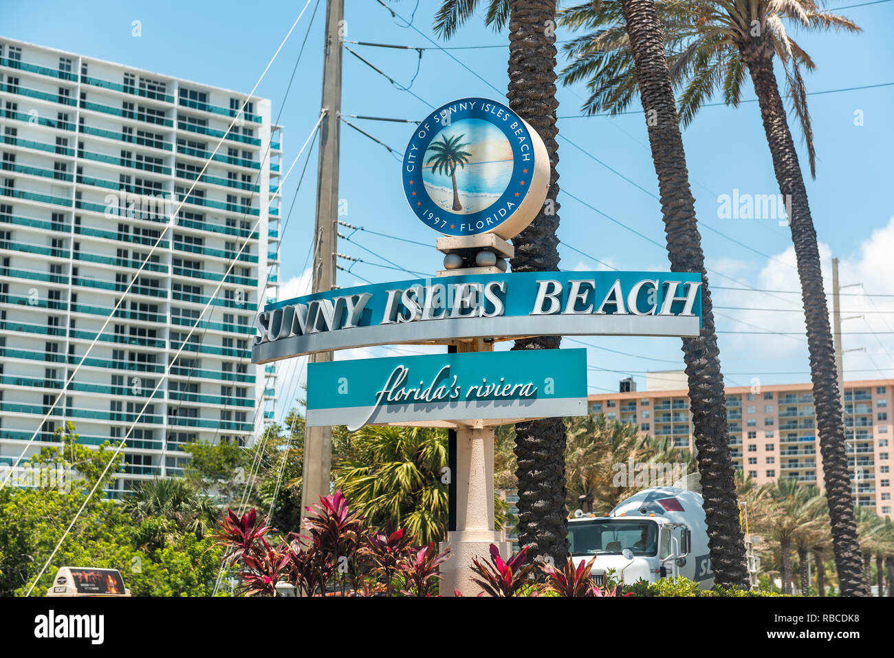 Sunny Isles Beach, USA - May 8, 2018: Sign for community city in North Miami, Florida, blue text on A1A Collins Avenue road street closeup Stock Photo