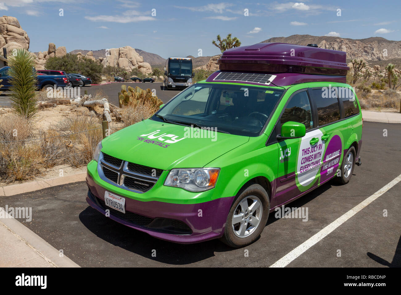 A Jucy RV Rentals Mini RV (called a JUCY Trailblazer) parked in the Joshua Tree National Park, California, United States. Stock Photo