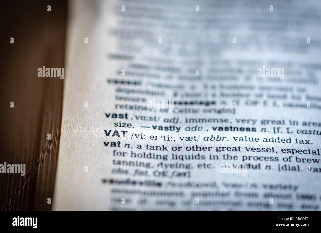 Close up of the abbreviation of the word value added tax - VAT - ion a page inside of an English Dictionary - VAT concept Stock Photo