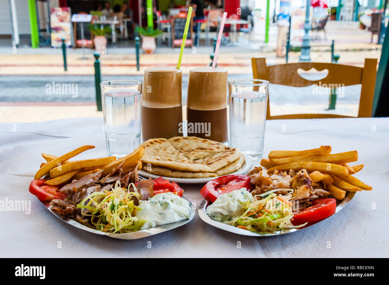 Traditional Greek hot dish Gyro or Gyros served on the plates. Pork or