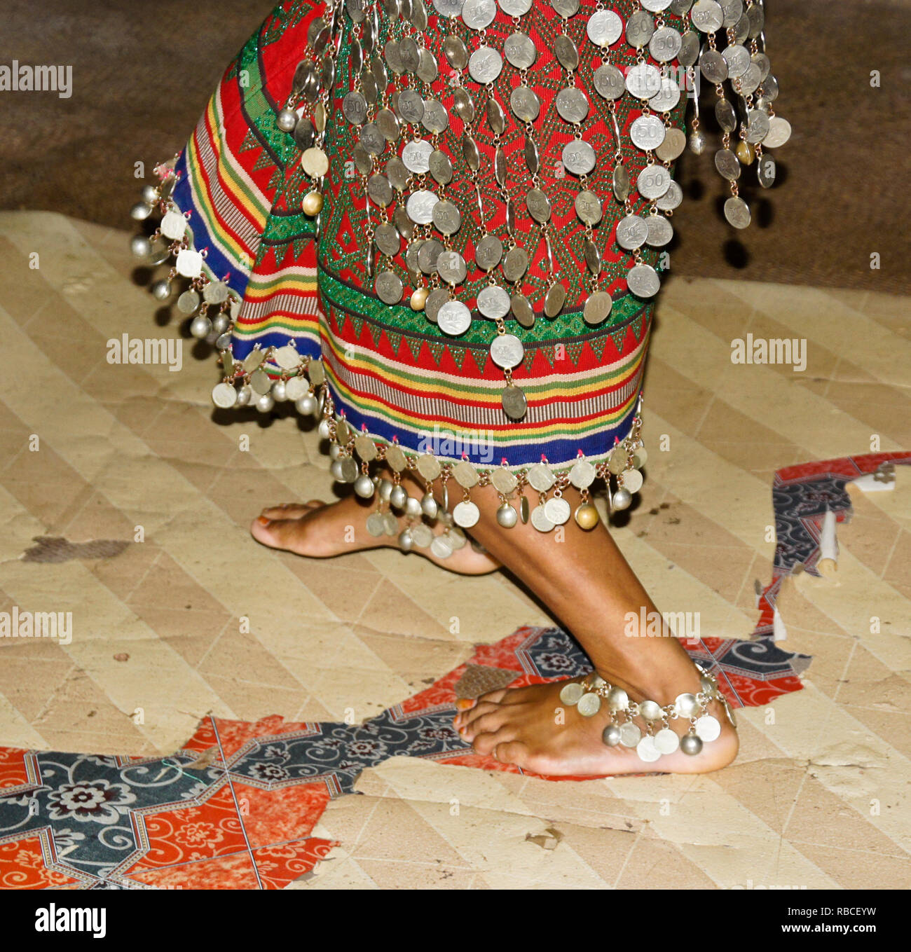 Iban woman dancing while wearing traditional tribal dress, Mengkak Longhouse, Batang Ai, Sarawak (Borneo), Malaysia Stock Photo