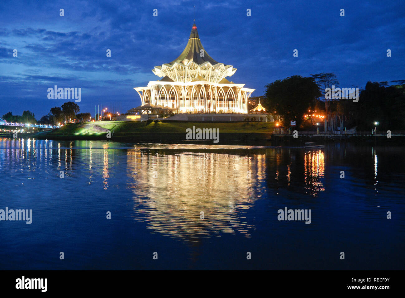 State Legislative Complex (lighted at night) on Sungai Sarawak (Sarawak River), Kuching, Sarawak (Borneo), Malaysia Stock Photo