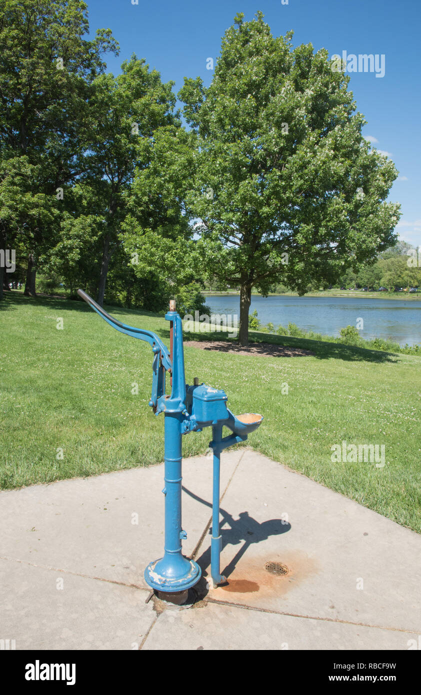 Water pump with Herrick Lake scenery during summer in Wheaton, Illinois