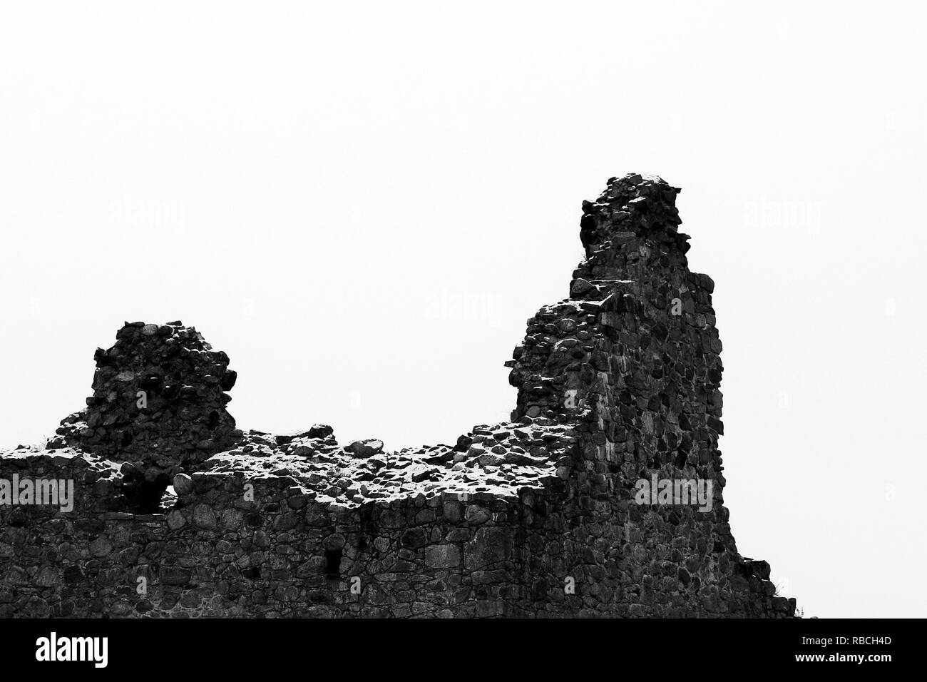 Collapsed ruins of old castle. Dramatic black and white image with copy space. Stock Photo