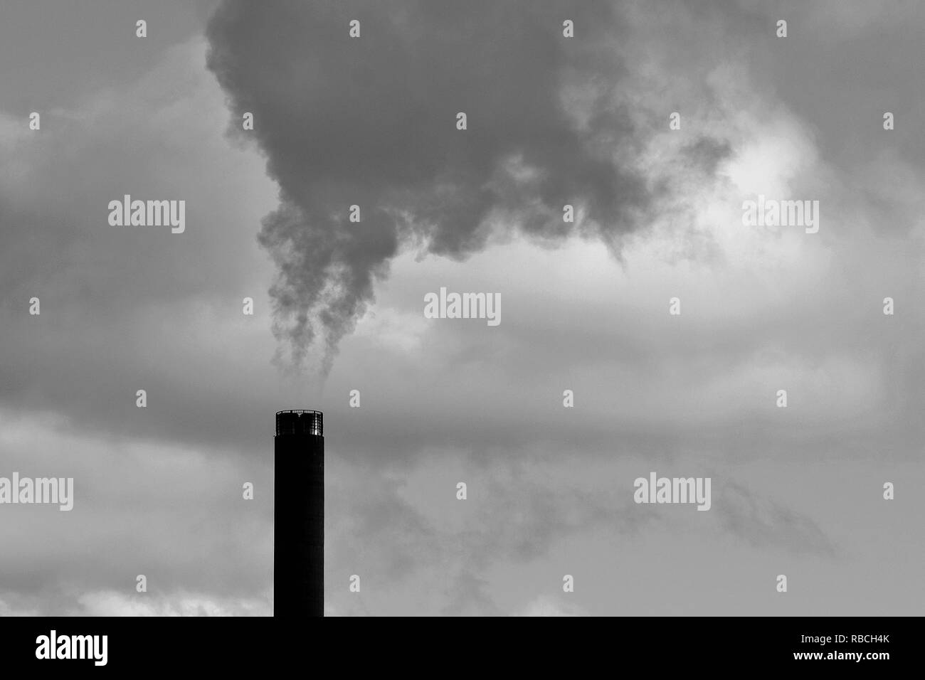 Smoke from chimney. Black and white image with copy space. Stock Photo
