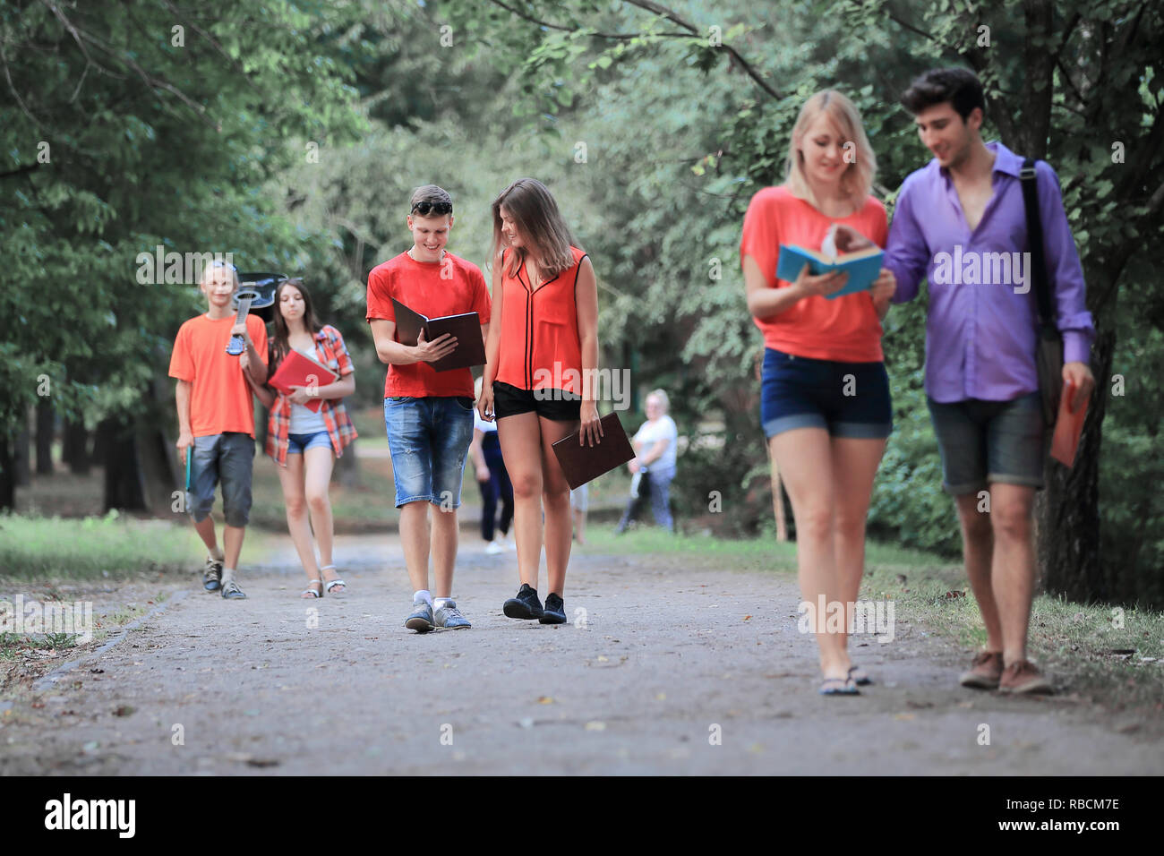 Group of College students on a walk in the Park Stock Photo - Alamy