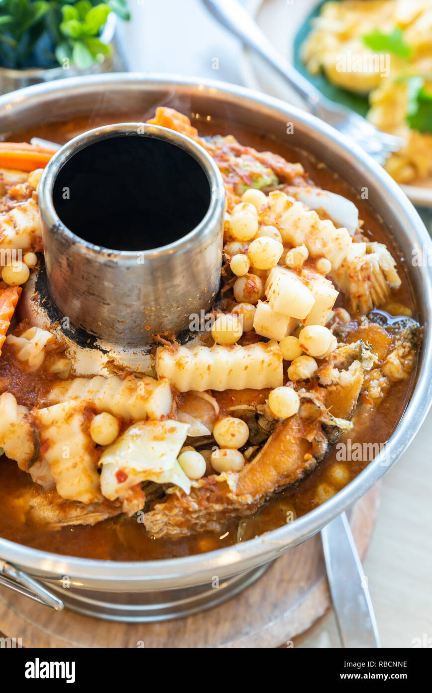 Sour curry soup with fried fish and seafood fish egg with mix vegatable