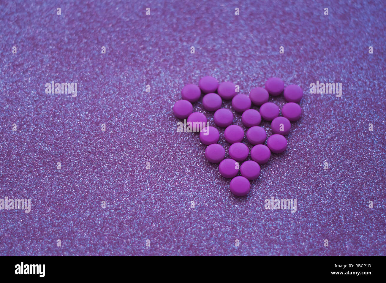 Pink heart pills hi-res stock photography and images - Alamy