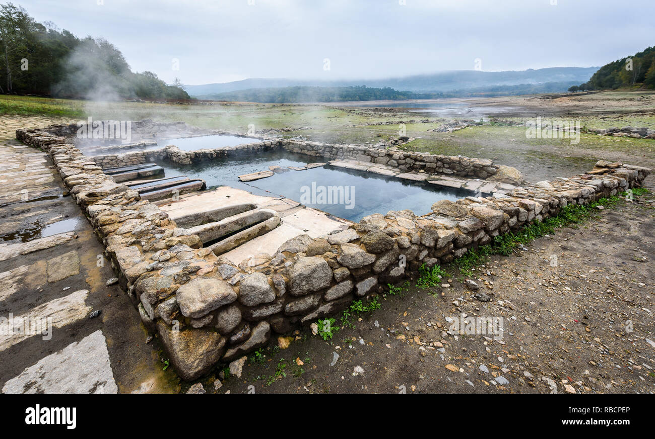 Natural Roman baths outdoors with hot steam and thermal water. Old