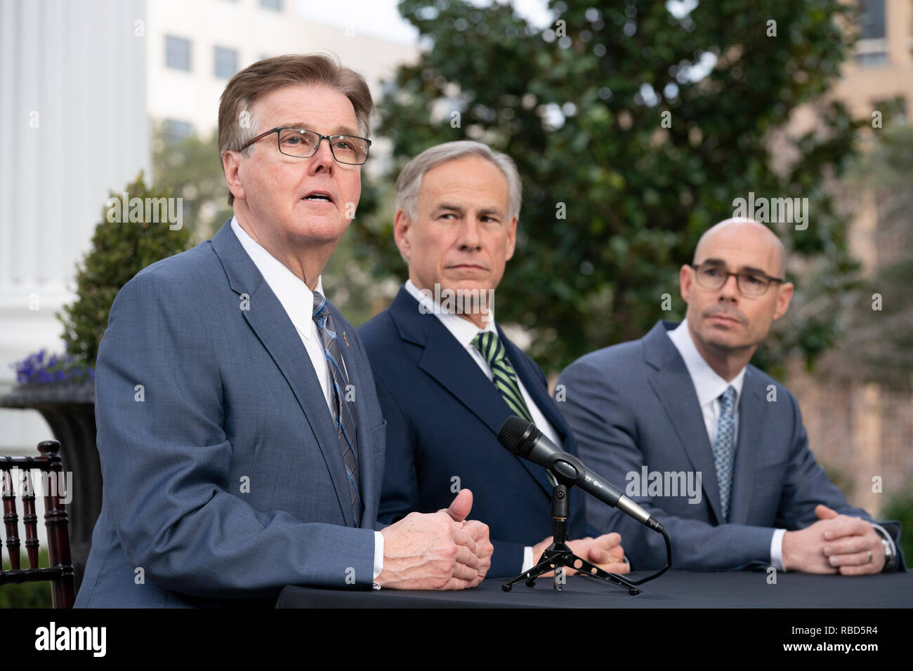 The leaders of Texas government, (from left) Lt. Gov. Dan Patrick, Gov. Greg Abbott and House Speaker Dennis Bonnen, meet the press outside the Governor's Mansion in Austin the day after the start of the 86th legislative session. Stock Photo