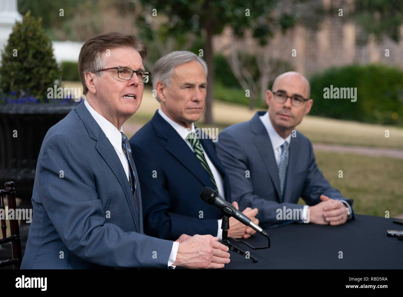 The leaders of Texas government, (from left) Lt. Gov. Dan Patrick, Gov. Greg Abbott and House Speaker Dennis Bonnen, meet the press outside the Governor's Mansion in Austin the day after the start of the 86th legislative session. Stock Photo