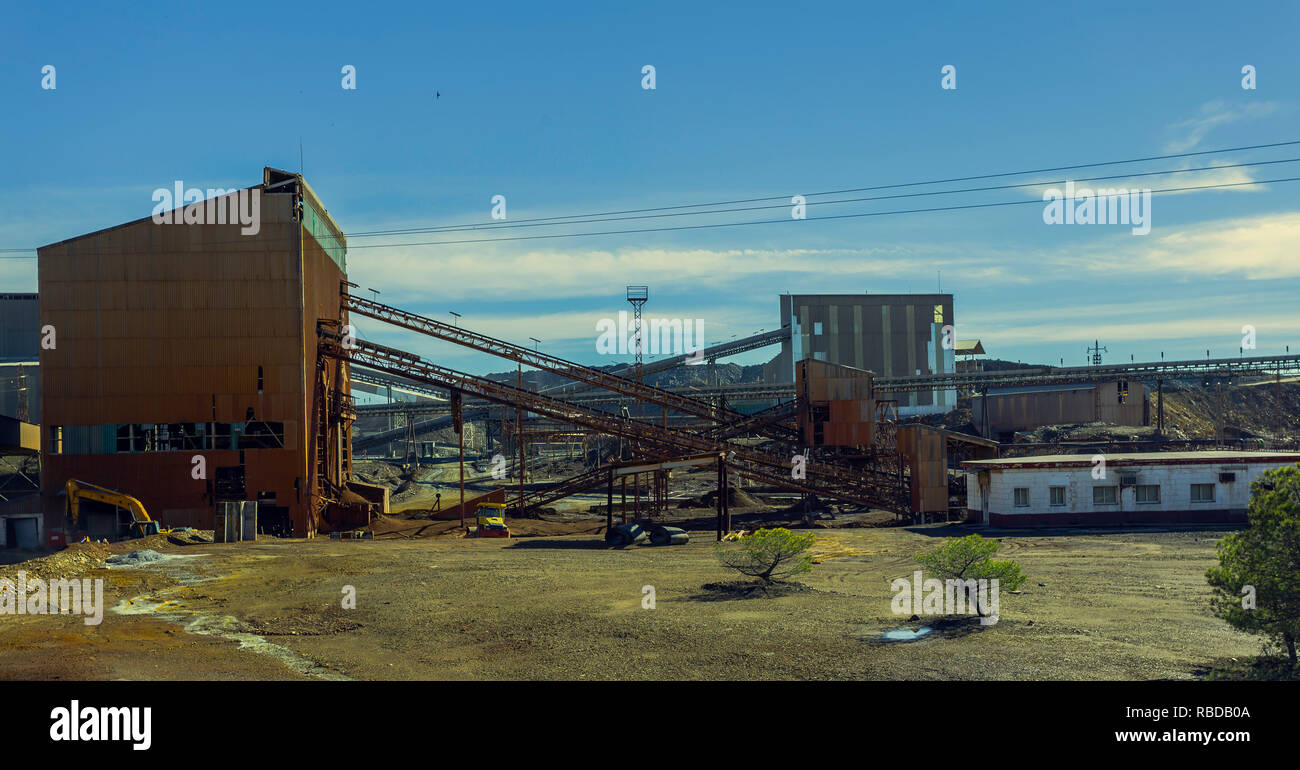 Old mining complex of Riotinto with mineral conveyor belts and old mining buildings, where gold and copper are extracted Stock Photo