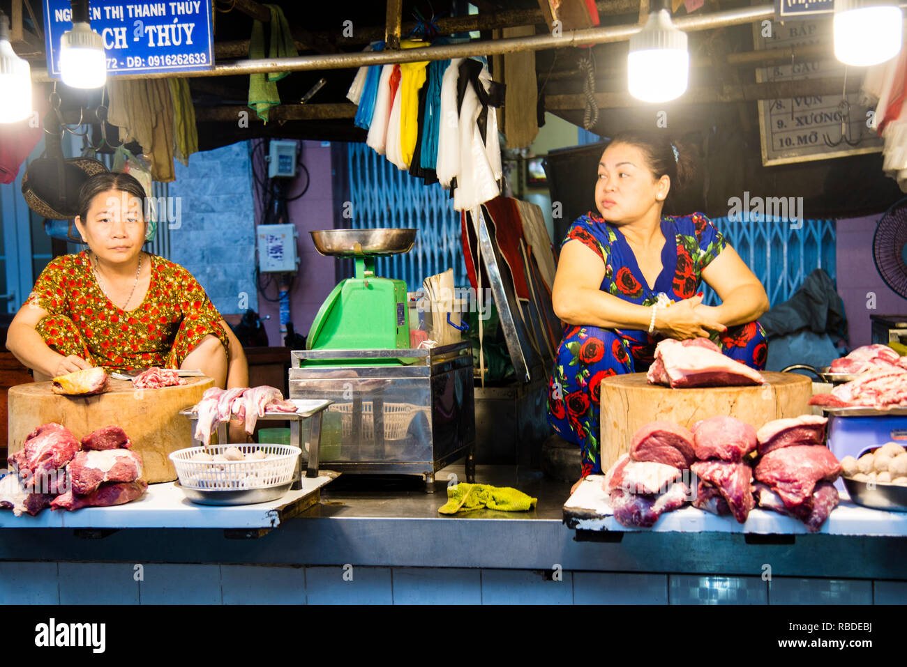 Vietnamese meat vendors at a local street market in Saigon, Vietnam
