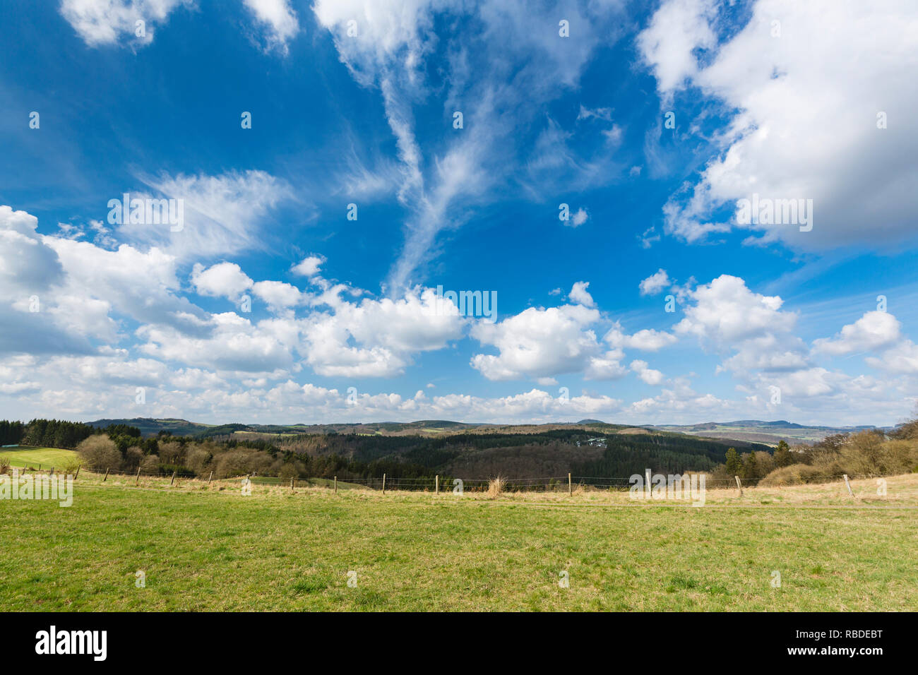 View over the southern Eifel hills near Daun, Germany with blue sky. Stock Photo