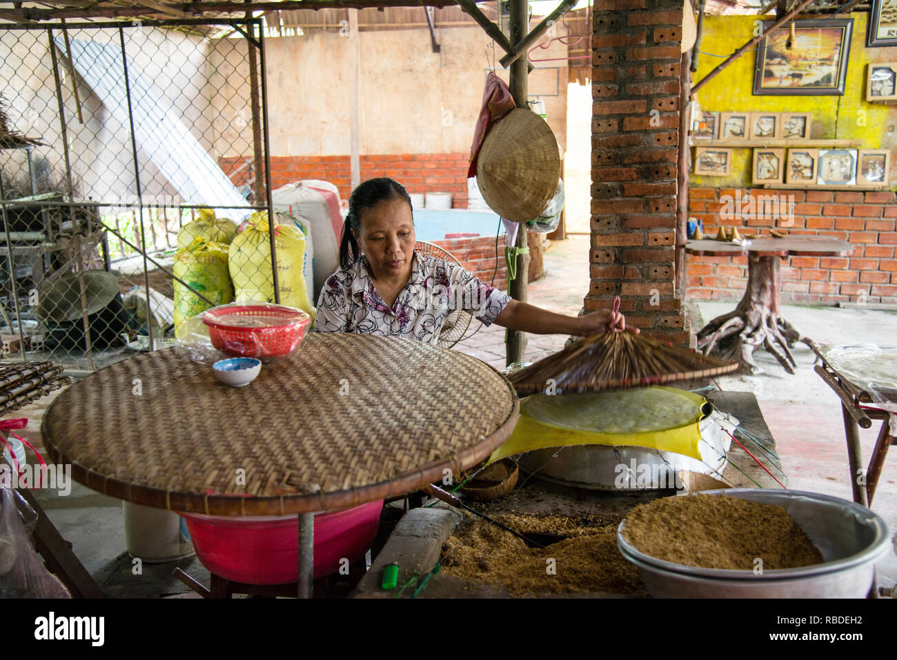 The art of handmade rice paper wrappers in a village on the Saigon River in Vietnam. Stock Photo