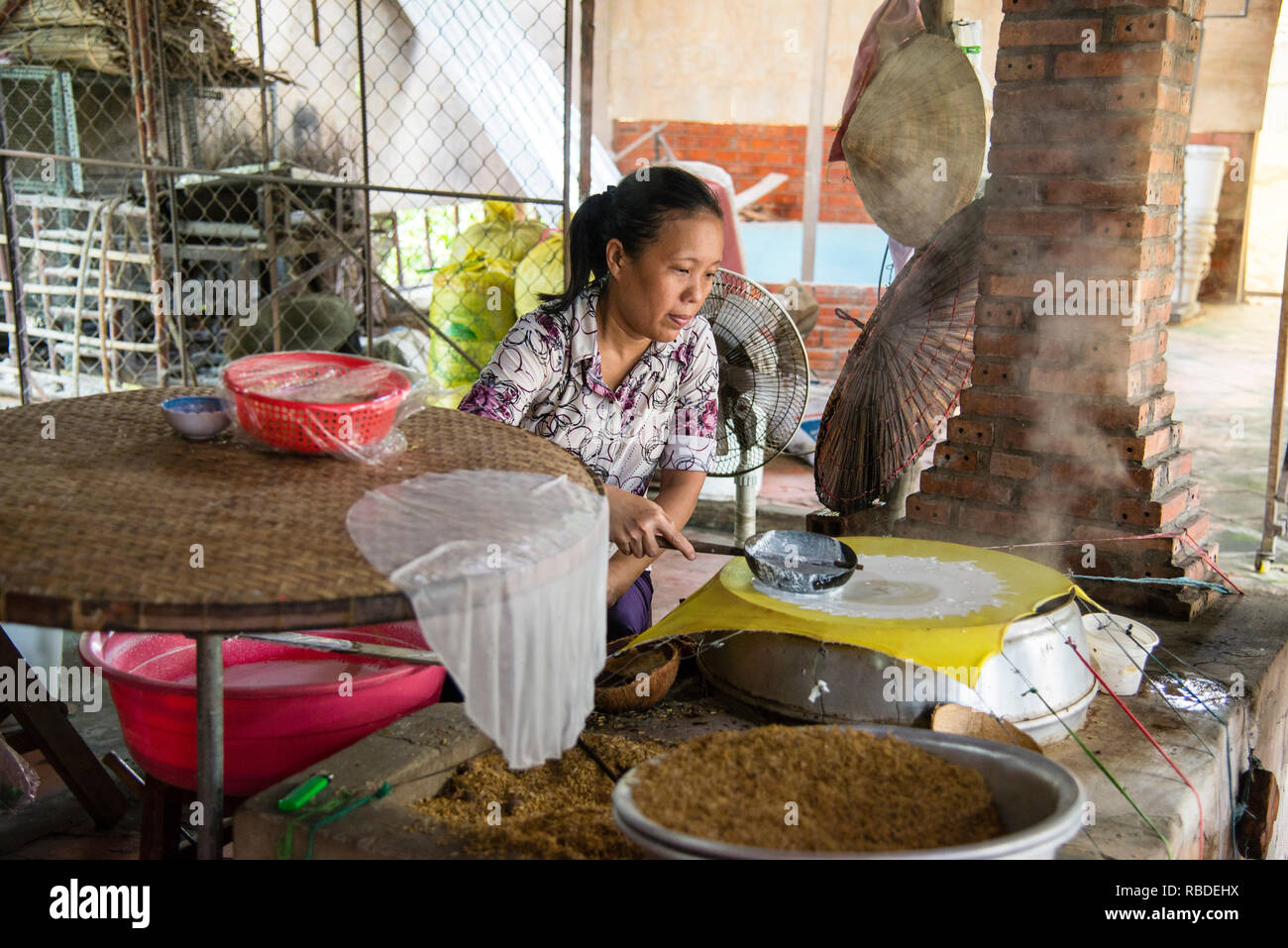 The art of handmade rice paper wrappers in a village on the Saigon River in Vietnam. Stock Photo