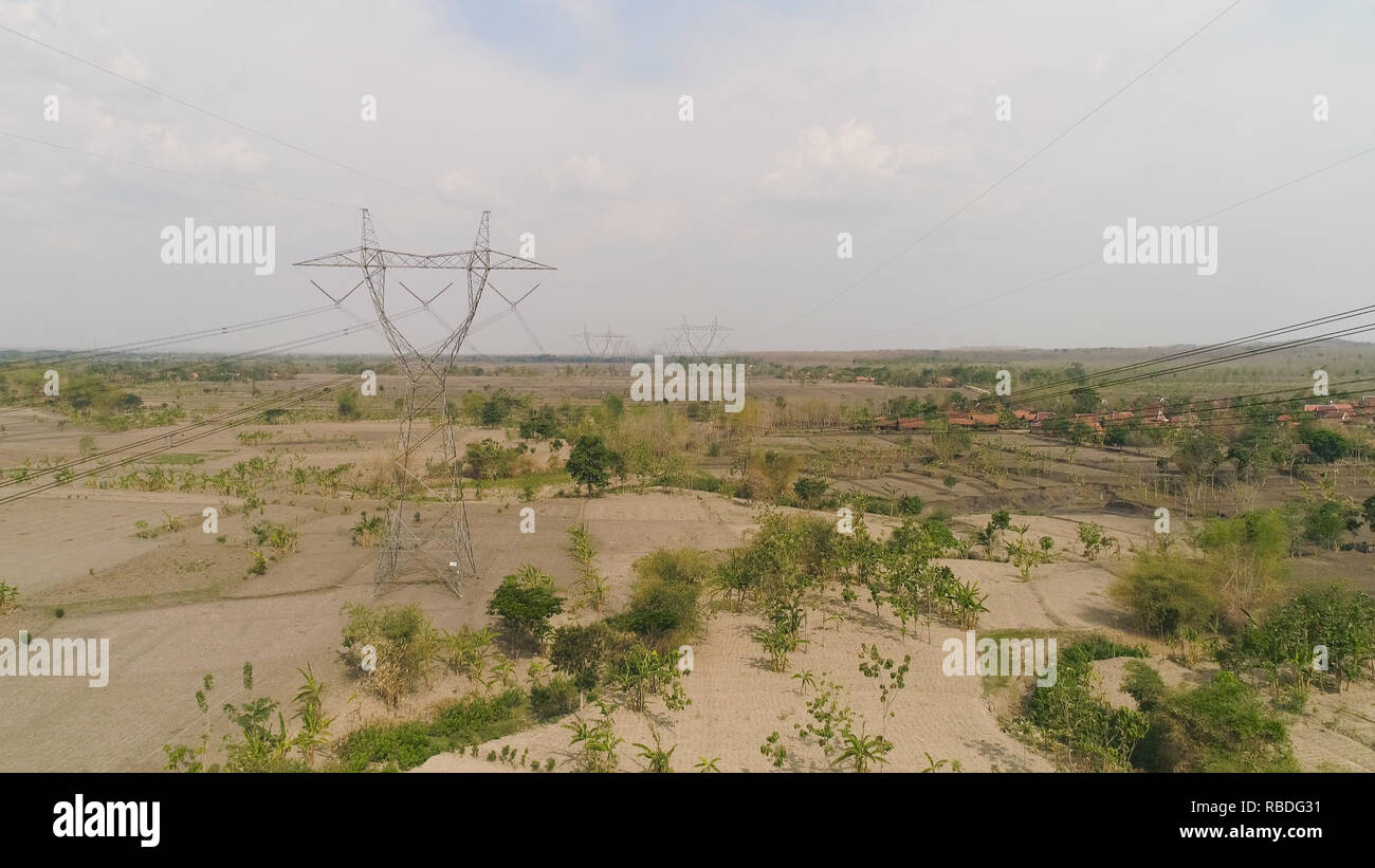 Electricity pylons bearing power supply across rural landscape. aerial ...