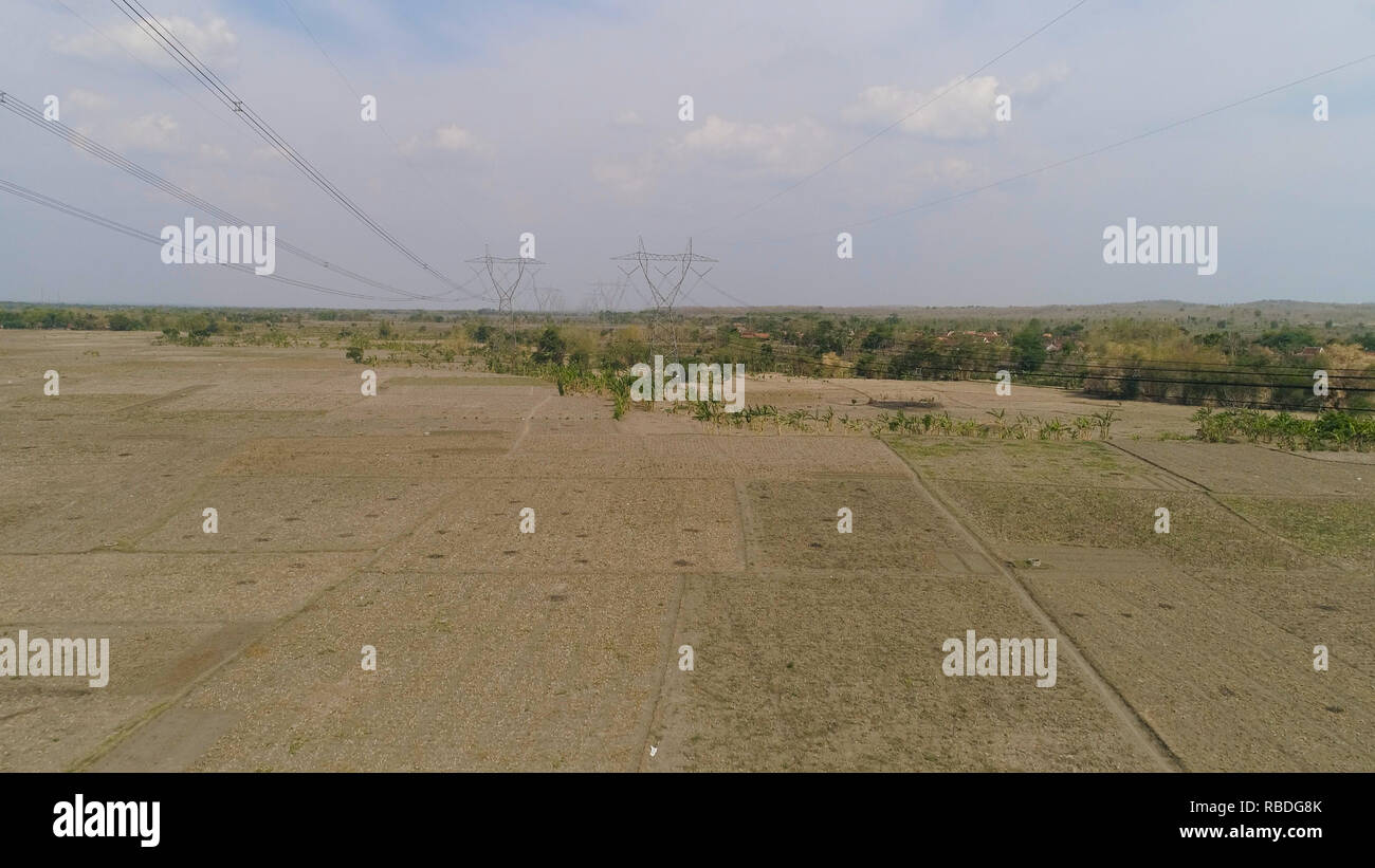 Electricity pylons bearing power supply across rural landscape. aerial ...