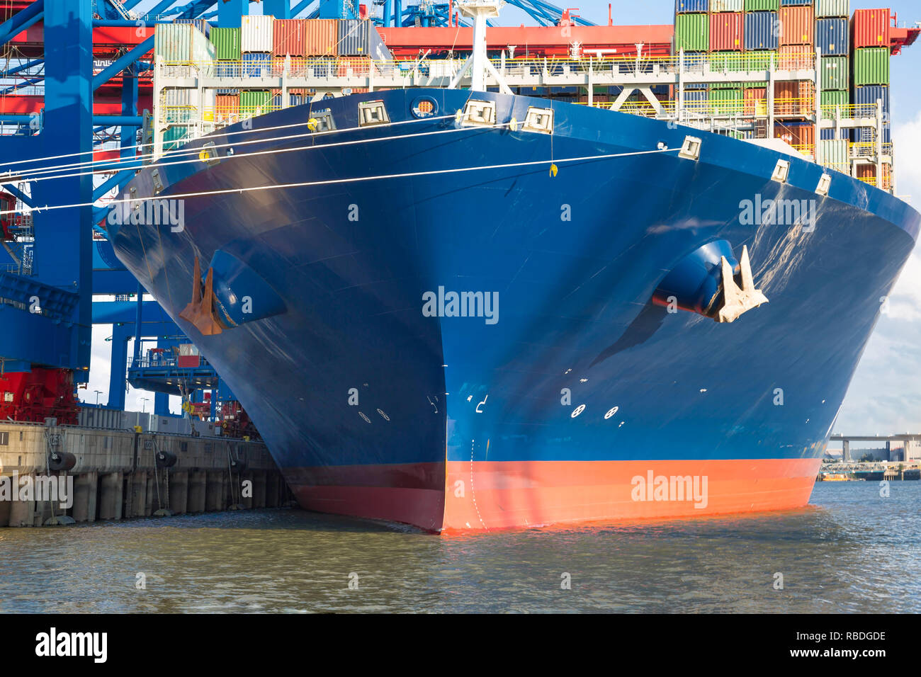Big blue Container ship during loading at the quayside Stock Photo