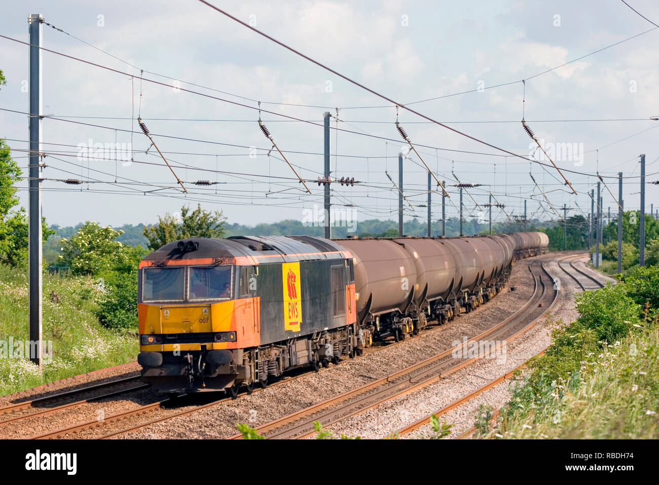 A class 60 diesel locomotive number 60007 working a freight train of empty bogie oil tanks near East Hyde on the Midland Mainline. Stock Photo