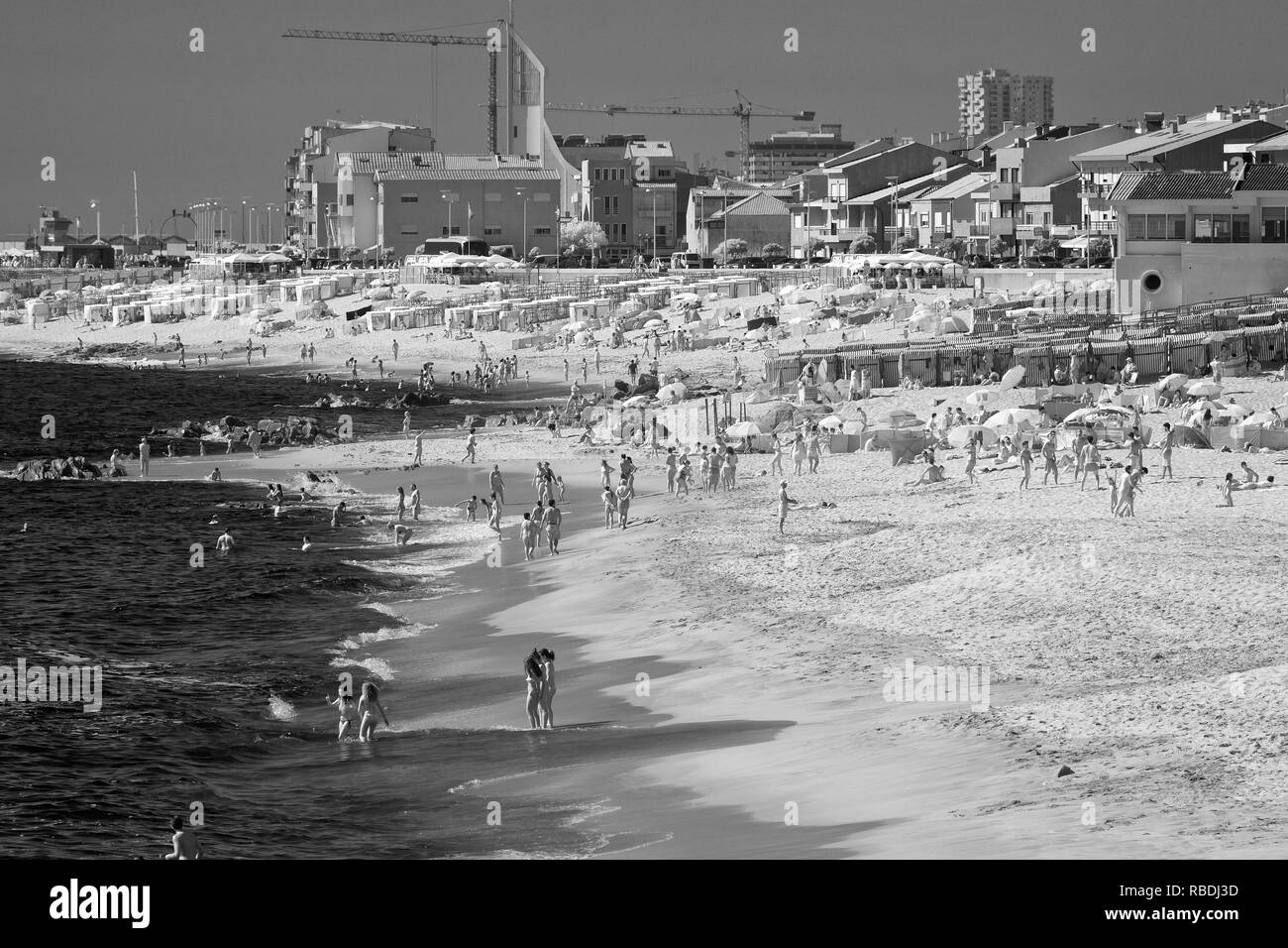 Vila do Conde, Portugal - July 16, 2015: Crowded ocean beach during the bathing season. Infrared black and white. Stock Photo