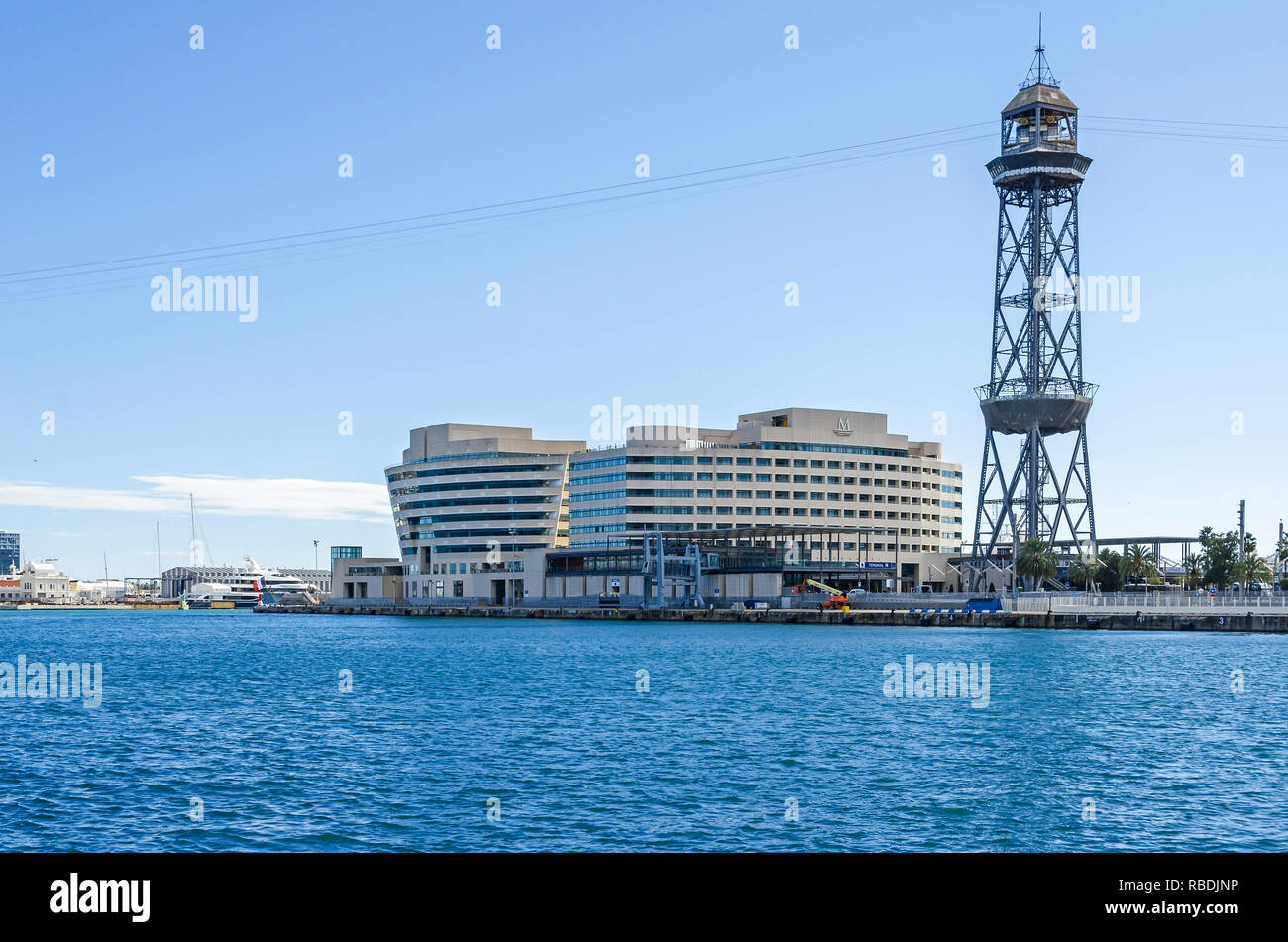 Barcelona, Spain - November 10, 2018: Barcelona Cruise Port with its steel truss tower of the aerial tramway Torre Jaume I, buildings of the World Tra Stock Photo