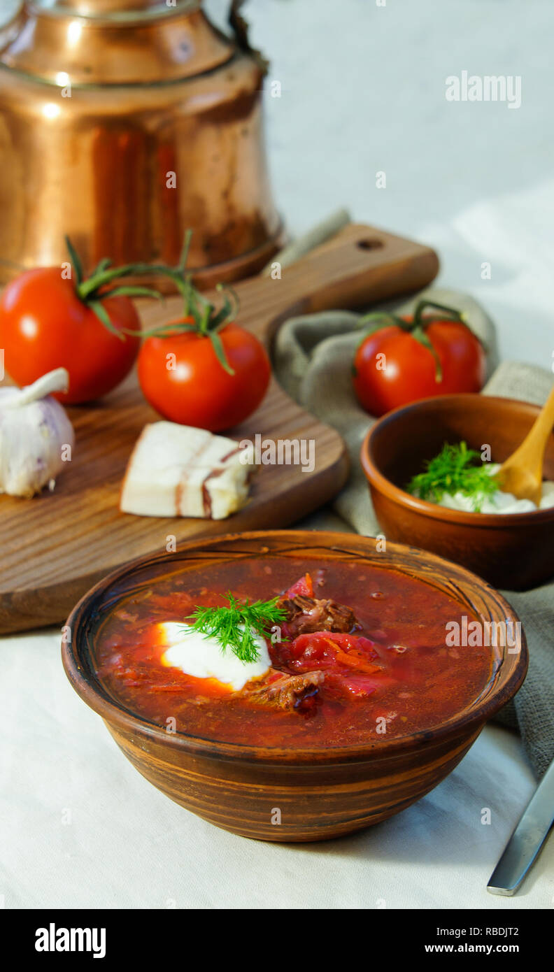 Homemade Russian, Ukrainian and Polish national soup - red borscht made of beetrot, vegetables and meat with sour cream Top view. Stock Photo