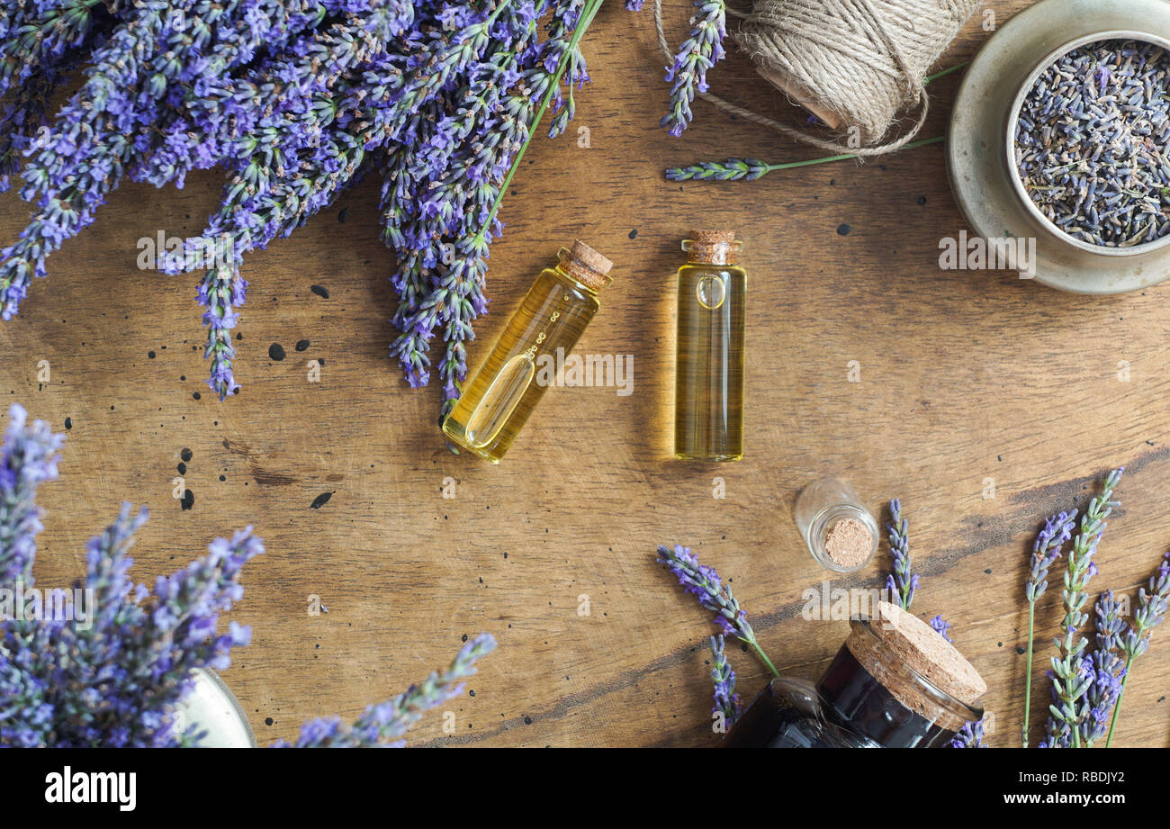 lavender oil bottles,  natural herb cosmetic consept with lavender flowers flatlay on stone background Stock Photo