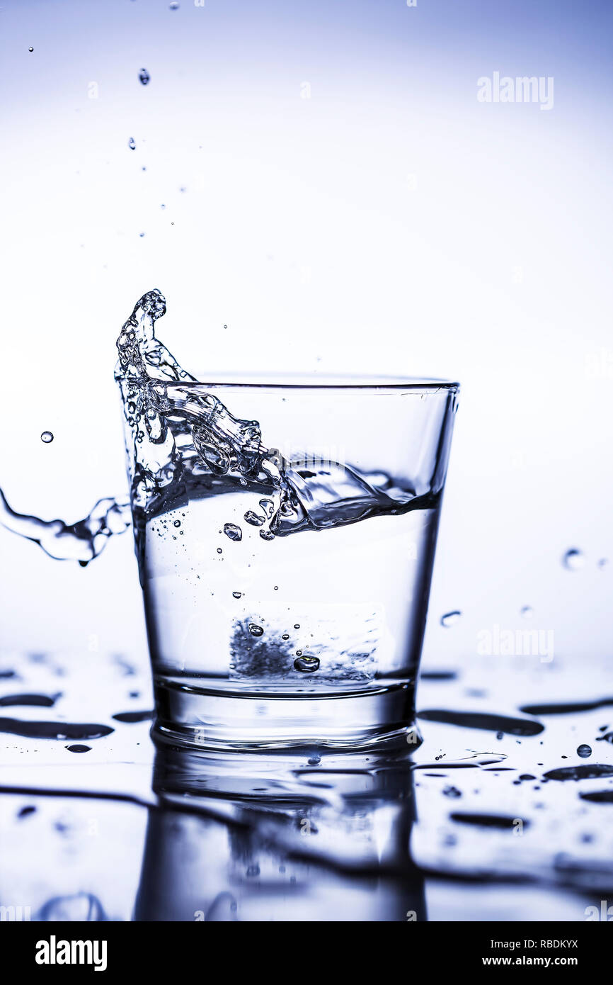 Splash ice cubes in a water glass Stock Photo - Alamy