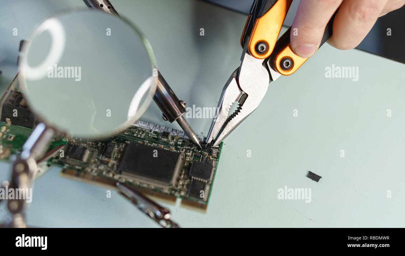 Repair motherboard. Service technician changes on-chip microcontroller ...