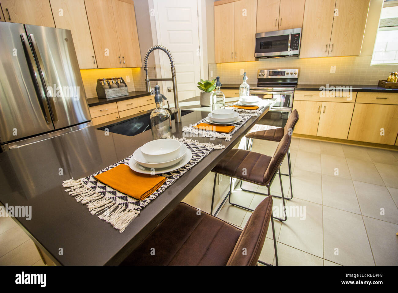 Granite Kitchen Counter Island With Stools And Place Settings Stock